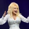 Dolly Parton sonríe durante una presentación sobre el escenario